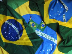 Multiple Brazilian flags displayed together, showcasing the green, yellow, blue, and white colors with the phrase 'Ordem e Progresso